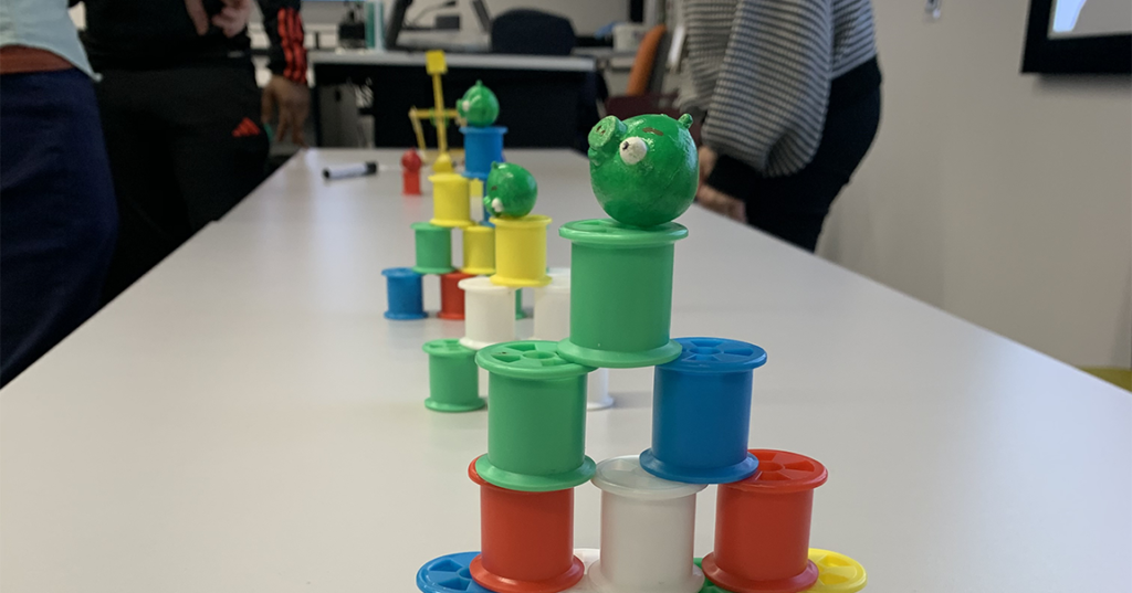 Angry birds catapult aimed at plastic spools